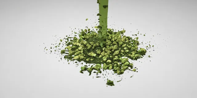 Lime pieces and a green liquid column in a splash study.