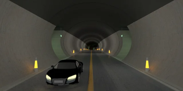 A car inside a long tunnel, framed by receding lights and exit signs.